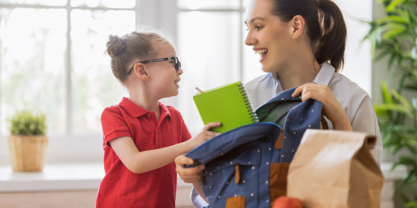 small girl and her mom preparing for the school day