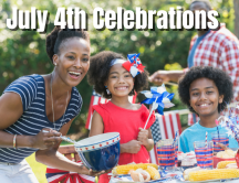Happy family grilling outside dressed for July 4th celebration